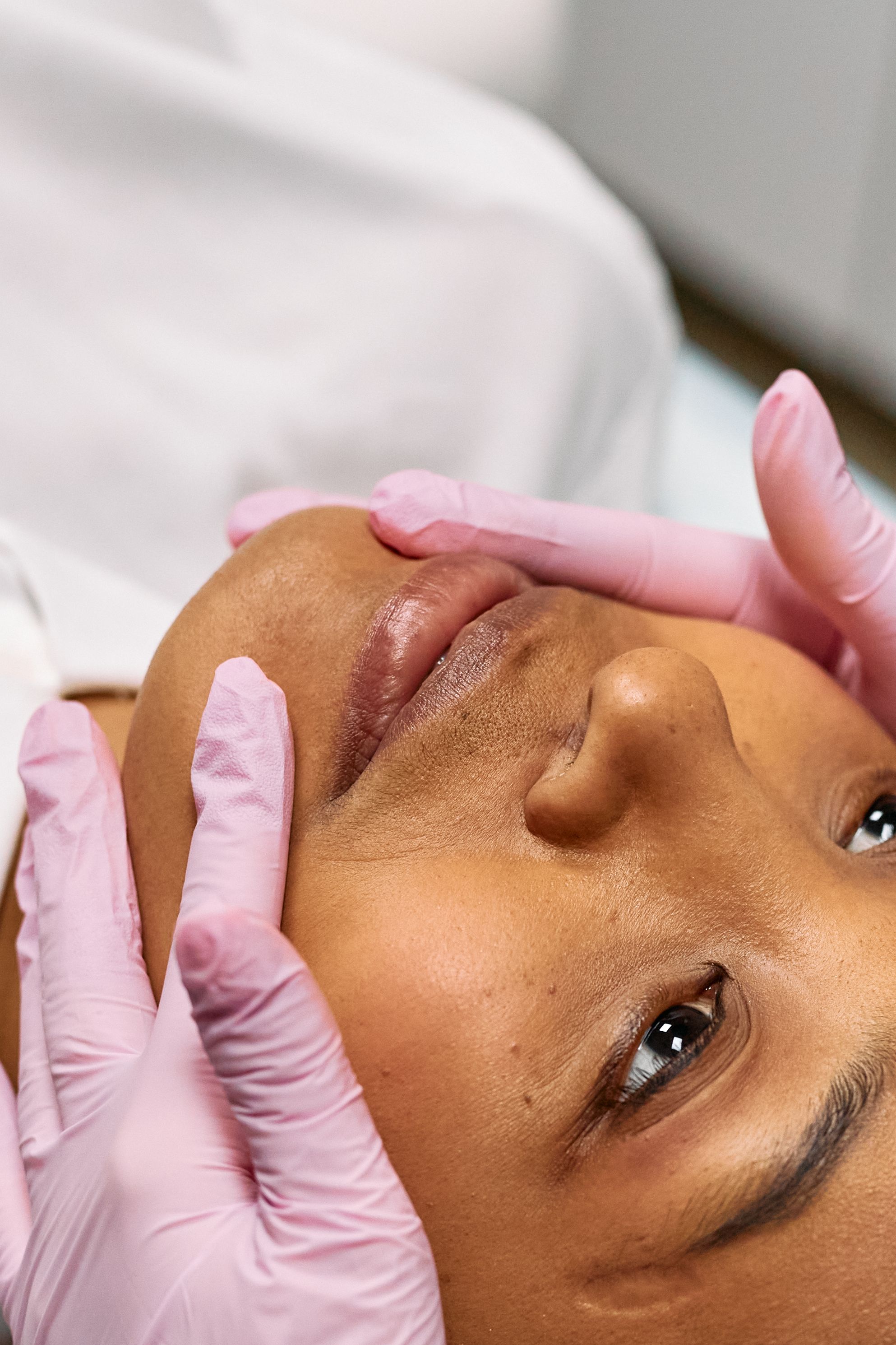 Practitioner performing a signature facial treatment